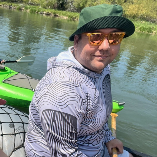 Chris paddling on a lake.