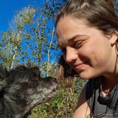 Rae smiling at her dog.